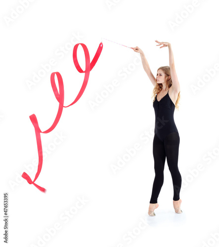 Photo: Beautiful ballerina in black suit with red ribbon stands Beautiful ballerina in black suit with red ribbon stands