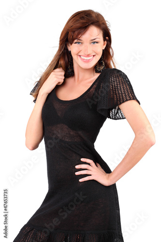 Photo: Beautiful girl in black dress and bid earrings smiles Beautiful girl in black dress and bid earrings smiles