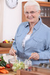 Senior woman preparing salad