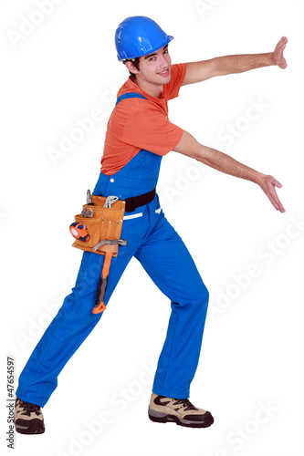 Photo: Tradesman pushing an invisible wall Tradesman pushing an invisible wall