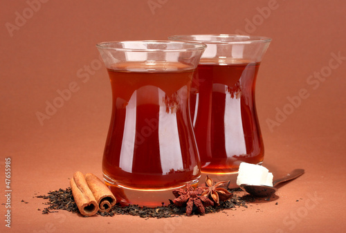 Photo: glasses of Turkish tea, on brown background glasses of Turkish tea, on brown background