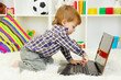 cute little boy and notebook in room
