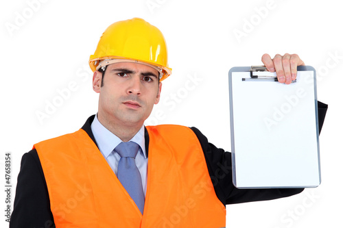 Photo: angry businessman holding a clip board angry businessman holding a clip board