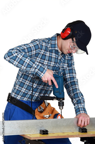 Photo: craftsman working with a drill craftsman working with a drill