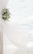 Photo: fresh white flowers as wedding decoration on beach isolated over fresh white flowers as wedding decoration on beach isolated over
