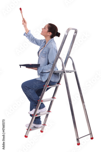 Photo: Woman painting a room Woman painting a room