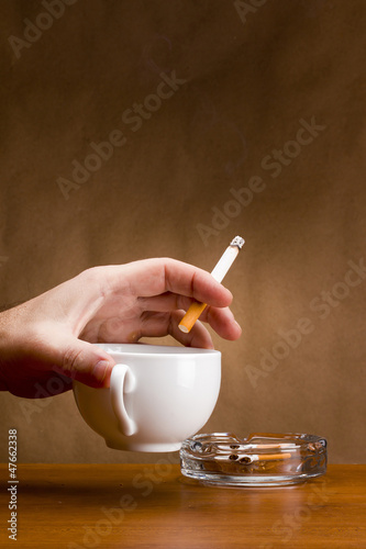 Photo: Hand holding a cigarette Hand holding a cigarette