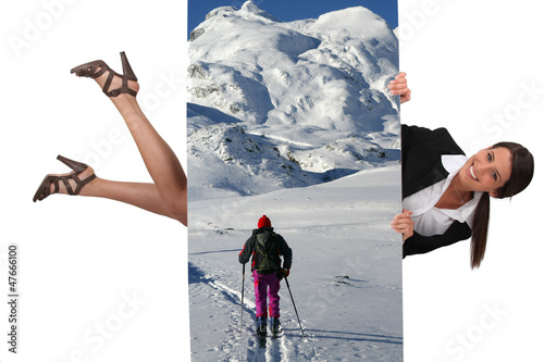 Photo: businesswoman holding a vacation poster businesswoman holding a vacation poster