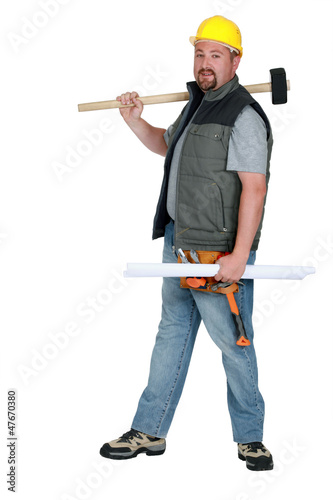Photo: Laborer holding plans and sledge-hammer Laborer holding plans and sledge-hammer