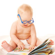 Baby in glasses reading a book and learning