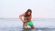 Video: Beautiful woman holding her baby and playing in ocean Beautiful woman holding her baby and playing in ocean