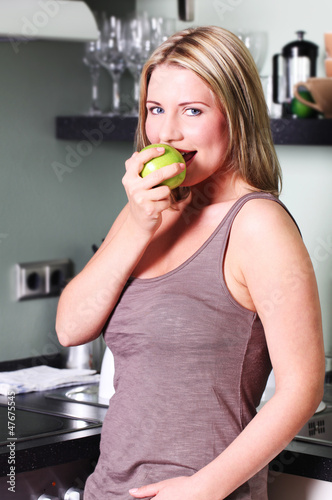 Photo: Young Woman Eating an Apple Young Woman Eating an Apple