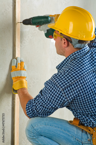 Photo: man drilling wall man drilling wall