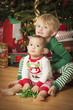 Mixed Race Baby and Young Boy Enjoying Christmas Morning Near Th
