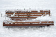 Wooden bench with snow