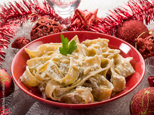 Photo: pasta with ricotta and pine nuts on christmas table pasta with ricotta and pine nuts on christmas table