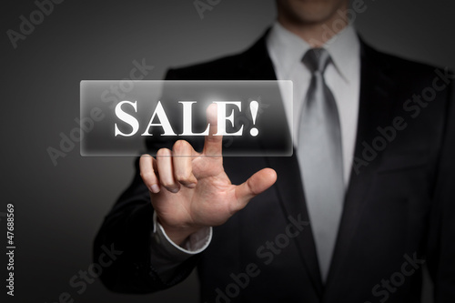 Photo: businessman pressing virtual touchscreen button - sale businessman pressing virtual touchscreen button - sale