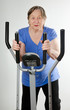 Senior woman on stationary training bicycle