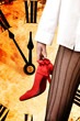 Фото: woman leg in stockings with red boots on clock background woman leg in stockings with red boots on clock background