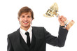 Handsome man in a suit with prize cup