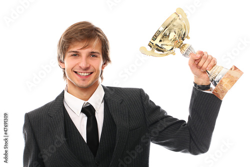 Photo: Handsome man in a suit with prize cup Handsome man in a suit with prize cup