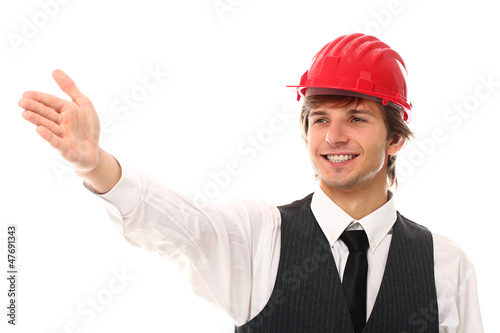 Photo: Young man in red helmet showing gesture Young man in red helmet showing gesture