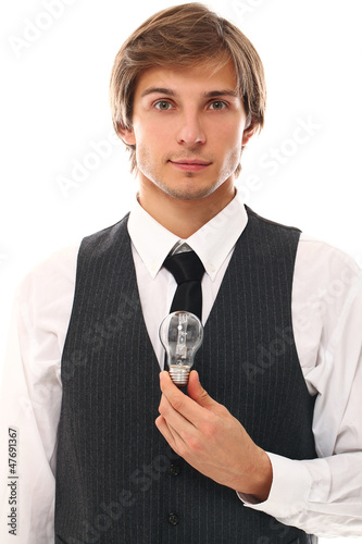 Photo: Handsome businessman holding lamp Handsome businessman holding lamp