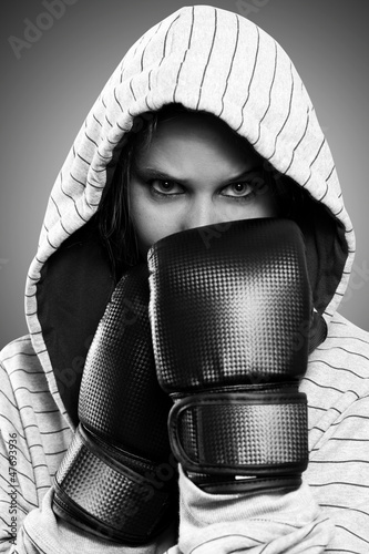 Photo: Black and white portrait of a woman with boxing gloves Black and white portrait of a woman with boxing gloves