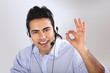 Young man calling with a headset. Isolated on white background