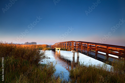 Photo: wooden bridge at sunrise wooden bridge at sunrise