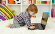 cute little boy and notebook in room
