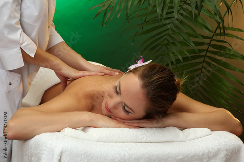 Photo: beautiful young woman in spa salon getting massage, beautiful young woman in spa salon getting massage,
