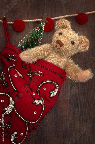 Photo: Antique teddy bear in stocking Antique teddy bear in stocking