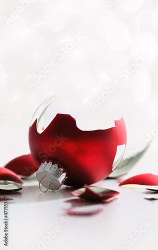 Photo: Broken red christmas ball on table Broken red christmas ball on table