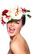 beautiful woman with bright makeup with colorful flowers on head