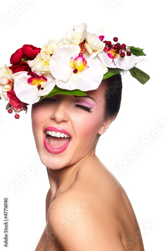 Photo: beautiful woman with bright makeup with colorful flowers on head beautiful woman with bright makeup with colorful flowers on head
