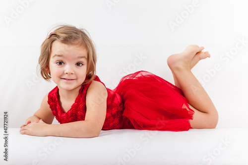 Photo: Cute playful little girl relaxing Cute playful little girl relaxing
