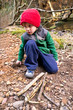 Little boy collecting fire wood on a fall day