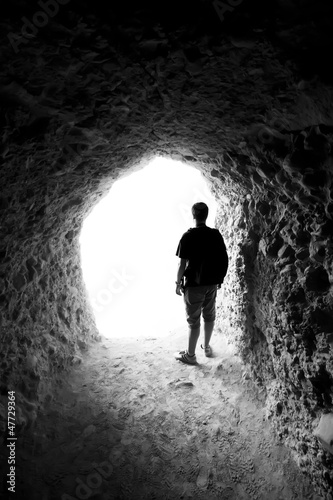 Fototapeta Man in a cave. Light at End of Tunnel
