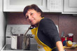 Photo: Woman in kitchen cooking meal at stove Woman in kitchen cooking meal at stove