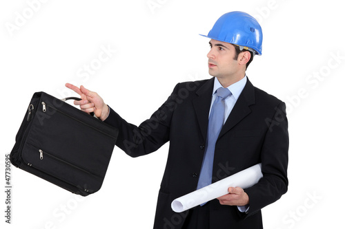 Photo: Businessman point to his right Businessman point to his right