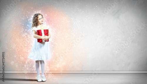 Photo: Happy girl opening gift box Happy girl opening gift box