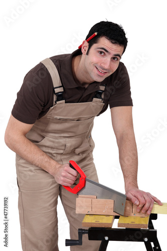 Photo: Carpenter using a handsaw Carpenter using a handsaw