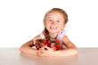 A child with a bowl fresh strawberries