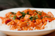 butter chicken sauce with rice and sliced carrots