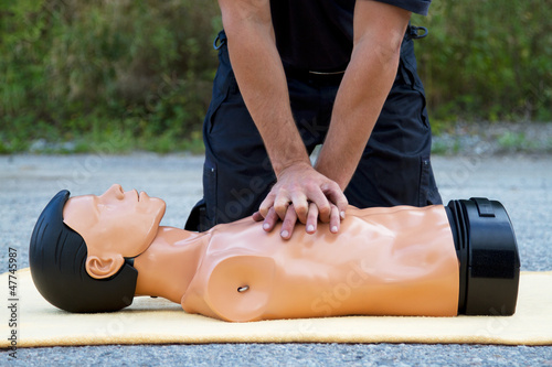 Photo: Male instructor showing CPR on training doll Male instructor showing CPR on training doll