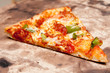 slice of pizza on a baking stone