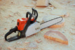 Photo: Chainsaw is on background wooden shavings Chainsaw is on background wooden shavings