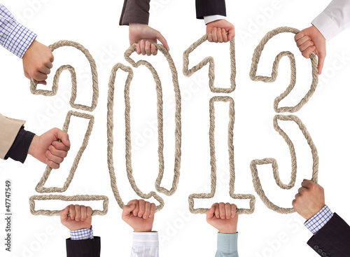 Photo: Hands holding bricks forming year 2013 Hands holding bricks forming year 2013