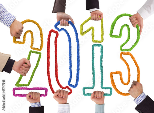 Photo: Hands holding bricks forming year 2013 Hands holding bricks forming year 2013